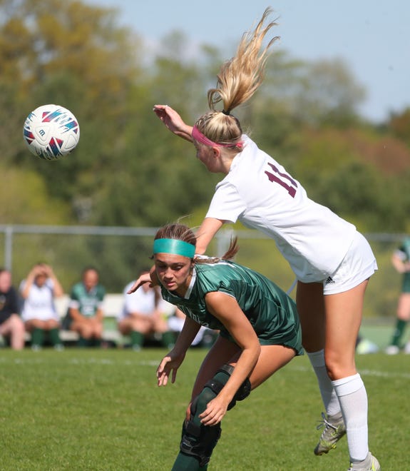 Saint Mark's Emma Manley (left) and Caravel's Lauren Pressler converge on the ball in the first half of the Bucs' 1-0 overtime win at Saint Mark's High School, Wednesday, April 24, 2024.