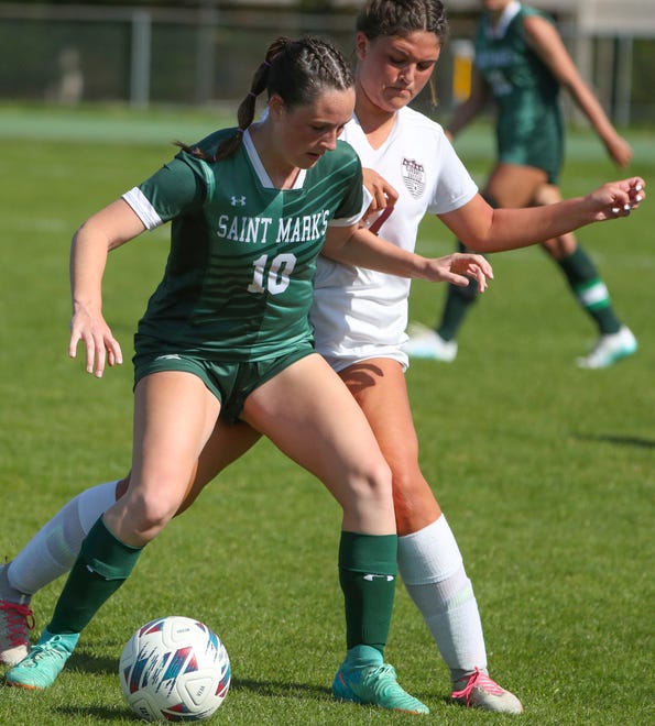 Saint Mark's Whitney Evancho (left) and Caravel's Reese Mushinski compete for the ball in the first half of the Bucs' 1-0 overtime win at Saint Mark's High School, Wednesday, April 24, 2024.