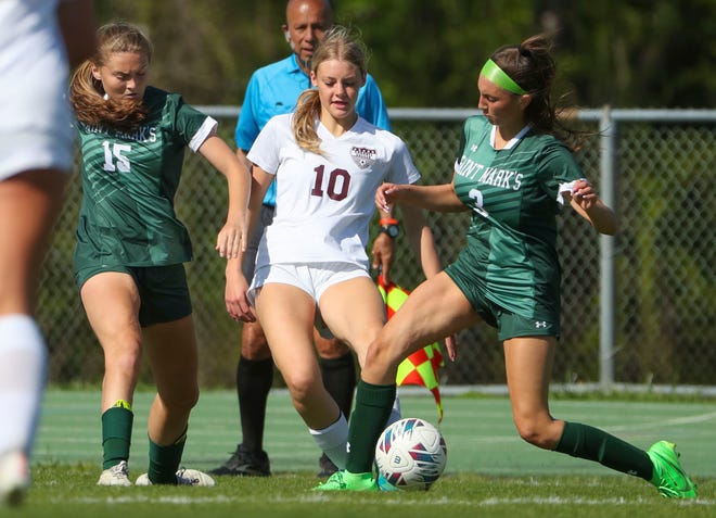 Saint Mark's Giana DiFebbo (left) and Presley Paoli work against Caravel's Sydney Hayden in the first half of the Bucs' 1-0 overtime win at Saint Mark's High School, Wednesday, April 24, 2024.