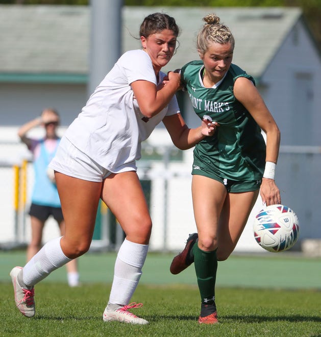 Caravel's Reese Mushinski (left) battles Saint Mark's Lily Phillips in the first half of the Bucs' 1-0 overtime win at Saint Mark's High School, Wednesday, April 24, 2024.