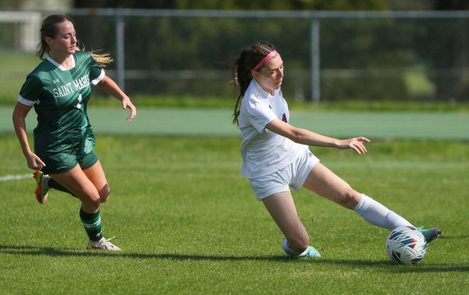 Saint Mark's Hailey Short (left) pursues as Caravel's Grace Slapcinsky tries to keep the ball inbounds in the first half of the Bucs' 1-0 overtime win at Saint Mark's High School, Wednesday, April 24, 2024.