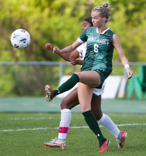 Saint Mark's Lily Phillips (6) tries to move the ball upfield in front of Caravel's Maci Hood in the second half of the Bucs' 1-0 overtime win at Saint Mark's High School, Wednesday, April 24, 2024.