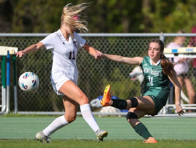 Caravel's Lauren Pressler (left) tries to stop Saint Mark's Naomi Love from advancing the ball in the second half of the Bucs' 1-0 overtime win at Saint Mark's High School, Wednesday, April 24, 2024.