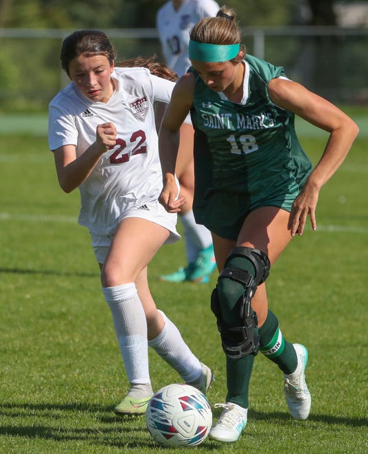 Caravel's Sierra Potts (left) pursues Saint Mark's Emma Manley in the second half of the Bucs' 1-0 overtime win at Saint Mark's High School, Wednesday, April 24, 2024.