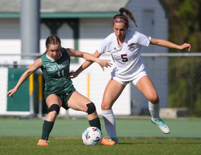 Saint Mark's Naomi Love (left) and Hailey Haynes vie for control of the ball in the second half of the Bucs' 1-0 overtime win at Saint Mark's High School, Wednesday, April 24, 2024.