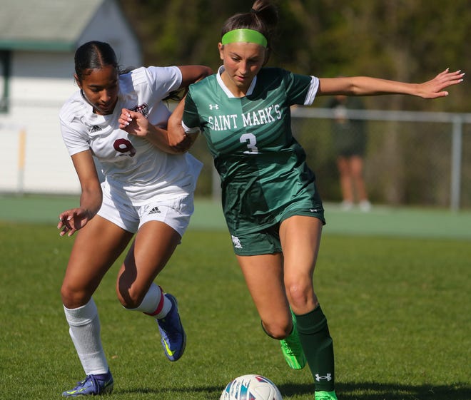 Caravel's Anaya Price (left) and Saint Mark's Presley Paoli fight for the ball near midfield in the second half of the Bucs' 1-0 overtime win at Saint Mark's High School, Wednesday, April 24, 2024.