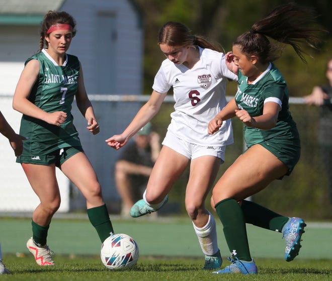 Saint Mark's Brynn Casapulla (left) and Julia McGonigle move against Caravel's Lacie Blessing in the Bucs' 1-0 overtime win at Saint Mark's High School, Wednesday, April 24, 2024.