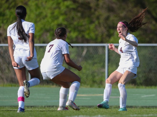 Caravel's Grace Slapcinsky (right) joins teammates Anaya Price (left) and Reese Mushinski in celebration after her corner kick went in the net for a 1-0 overtime win at Saint Mark's High School, Wednesday, April 24, 2024.