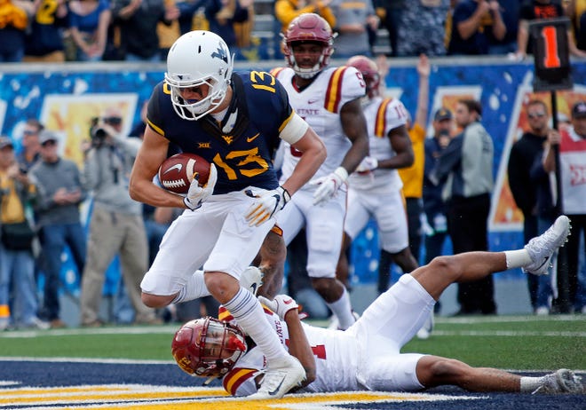 David Sills V #13 of the West Virginia Mountaineers catches a 10 yard touchdown pass in the first half against D'Andre Payne #1 of the Iowa State Cyclones at Mountaineer Field on November 04, 2017 in Morgantown, West Virginia.