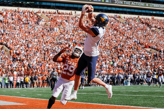 David Sills V #13 of the West Virginia Mountaineers catches a pass for a touchdown defended by Josh Thompson #29 of the Texas Longhorns in the second quarter at Darrell K Royal-Texas Memorial Stadium on November 3, 2018 in Austin, Texas.