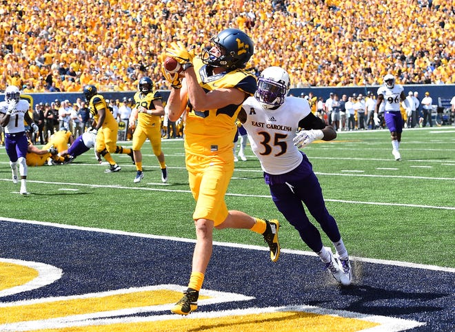 David Sills V #13 of the West Virginia Mountaineers makes a touchdown catch in front of Chris Love #35 of the East Carolina Pirates during the second quarter at Mountaineer Field on September 9, 2017 in Morgantown, West Virginia.