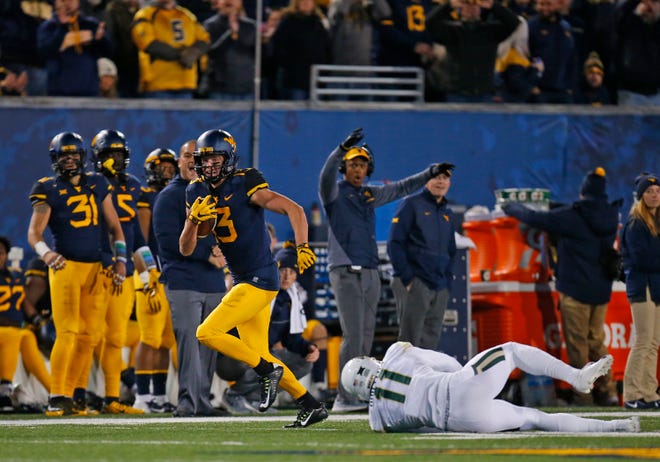 David Sills V #13 of the West Virginia Mountaineers catches a 65 yard touchdown pass in the first half against Jameson Houston #11 of the Baylor Bears at Mountaineer Field on October 25, 2018 in Morgantown, West Virginia.