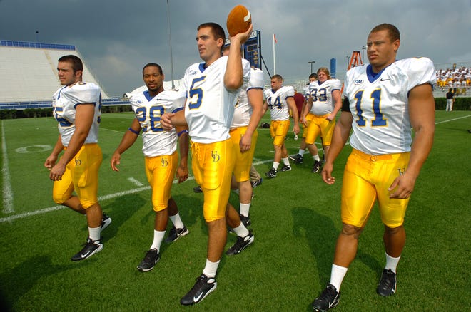 August 2007: UD football players walk across the field at Tubby Ramond Stadium Friday after having their photos taken for media day. (L to R) #55 Tim Prindle, #28 Omar Cuff, #5 Joe Flacco, and #11Matt Marcorelle.