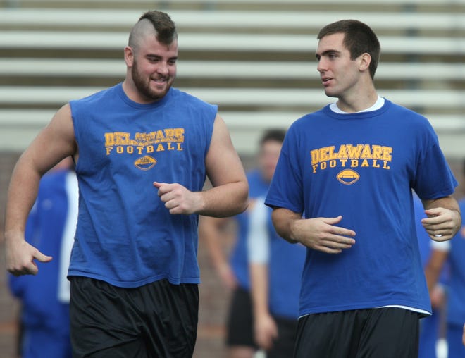 Delaware offensive lineman Rich Beverley and quarterback Joe Flacco trot onto the field during walk-through at Max Finley Stadium in Chattanooga, TN on the eve of the NCAA I-AA championship game, Thursday, Dec 13, 2007.