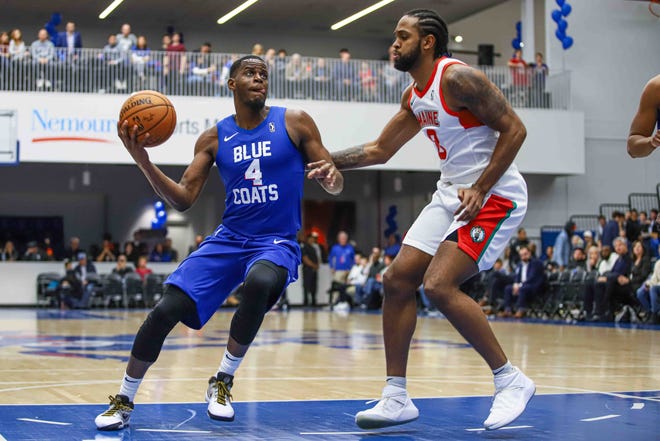 Delaware Bluecoats Forward JULIAN WASHBURN (4) drives to the basket as Maine Red Claws Forward SHELDON JETER (8) defends in the first half of a NBA G-League regular season basketball game between the Bluecoats and the Maine Red Claws (Boston Celtics) Saturday, Nov. 09, 2019, at the 76ers Fieldhouse in Wilmington, DE