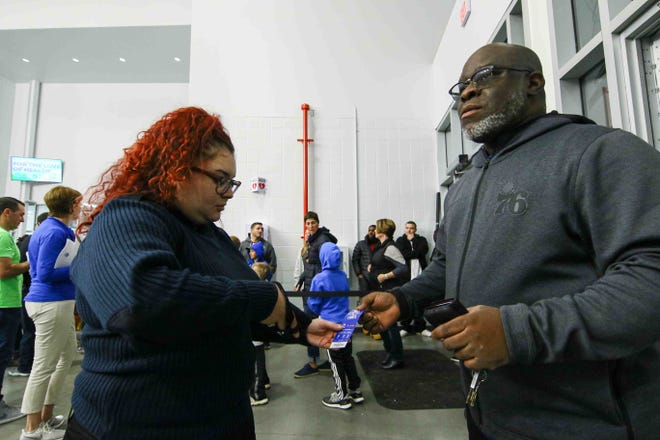 Fans have their tickets scanned at the entrance of the 76ers Fieldhouse prior to a NBA G-League regular season basketball game between the Bluecoats and the Maine Red Claws (Boston Celtics) Saturday, Nov. 09, 2019, at the 76ers Fieldhouse in Wilmington, DE