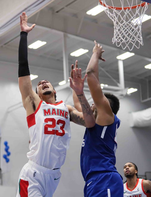 Maine Red Claws Center JOHN BOHANNON (23) drive to the hoop as Delaware Bluecoats Center DORAL MOORE (12) defends in the second half of a NBA G-League regular season basketball game between the Bluecoats and the Maine Red Claws (Boston Celtics) Saturday, Nov. 09, 2019, at the 76ers Fieldhouse in Wilmington, DE