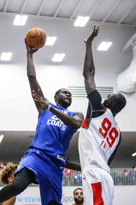 Delaware Bluecoats Center CHRIST KOUMADJE (20) drives to the basket as Maine Red Claws Center TACKO FALL (99) defends in the first half of a NBA G-League regular season basketball game between the Bluecoats and the Maine Red Claws (Boston Celtics) Saturday, Nov. 09, 2019, at the 76ers Fieldhouse in Wilmington, DE