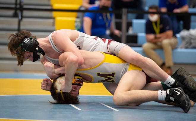 CaravelÕs Luke Poore (left) and MilfordÕs Corey Messick wrestle in the 120 pound championship match at the DIAA State Individual Wrestling Championship at Cape Henlopen High School Wednesday, March 3, 2021.