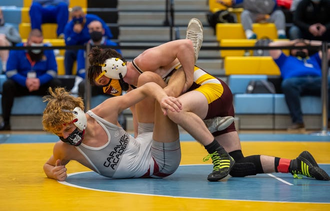CaravelÕs Dylan Knight (left) and MilfordÕs Jack Thode wrestle in the 126 pound championship match at the DIAA State Individual Wrestling Championship at Cape Henlopen High School Wednesday, March 3, 2021.