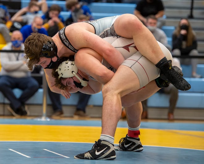 CaravelÕs Danny Stradley (bottom) and Cape HenlopenÕs Jackson Handlin wrestle in the 195 pound championship match at the DIAA State Individual Wrestling Championship at Cape Henlopen High School Wednesday, March 3, 2021.