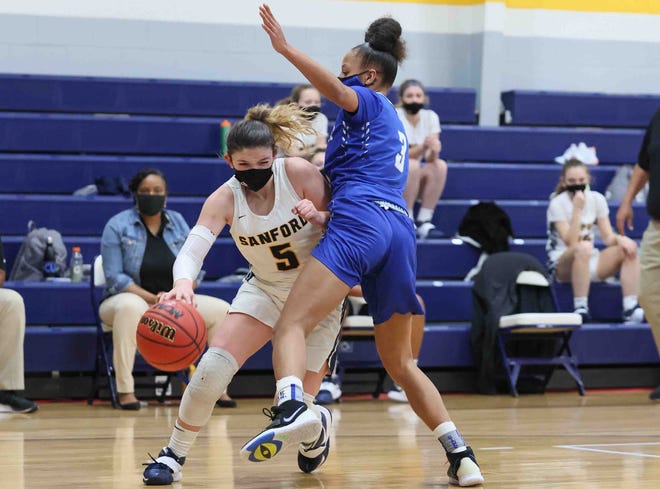 Sanford's Abby Meredith (left) pushes toward the basket against Woodbridge's Sierra Smith during a DIAA semifinal Wednesday, Mar. 10, 2021 at Sanford School.