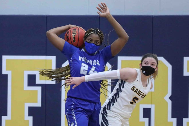 Sanford's Abby Meredith (5) and Woodbridge's Cha'Kya Johnson (24) attempt to grab a rebound during a DIAA semifinal Wednesday, Mar. 10, 2021 at Sanford School.