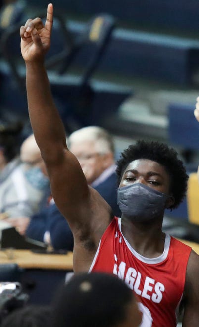 Smyrna's Olumuyiwa Salako enjoys his team's win after he nailed a free throw with under a second to play in the Eagles' 43-42 win in a semifinal of the DIAA state tournament at Salesianum Thursday, March 11, 2021.