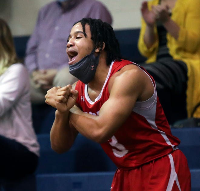 Smyrna's Yamir Knight cheers on his teammates in the Eagles' 43-42 win in a semifinal of the DIAA state tournament at Salesianum Thursday, March 11, 2021.