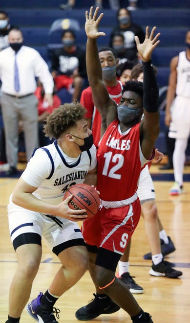 Salesianum's Jackson Conkey (left) looks to the basket past Smyrna's Olumuyiwa	Salako in the Eagles' 43-42 win in a semifinal of the DIAA state tournament at Salesianum Thursday, March 11, 2021.