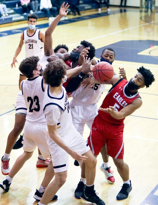 Smyrna's Olumuyiwa Salako is mobbed and fouled by the Salesianum defense after getting his own rebound with less than a second to play in the Eagles' 43-42 win in a semifinal of the DIAA state tournament at Salesianum Thursday, March 11, 2021.