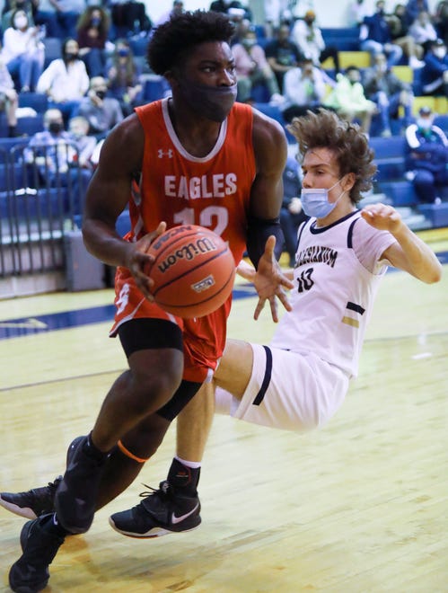 Smyrna's Olumuyiwa Salako (left) and Salesianum's Justin Molen collide in the Eagles' 43-42 win in a semifinal of the DIAA state tournament at Salesianum Thursday, March 11, 2021.