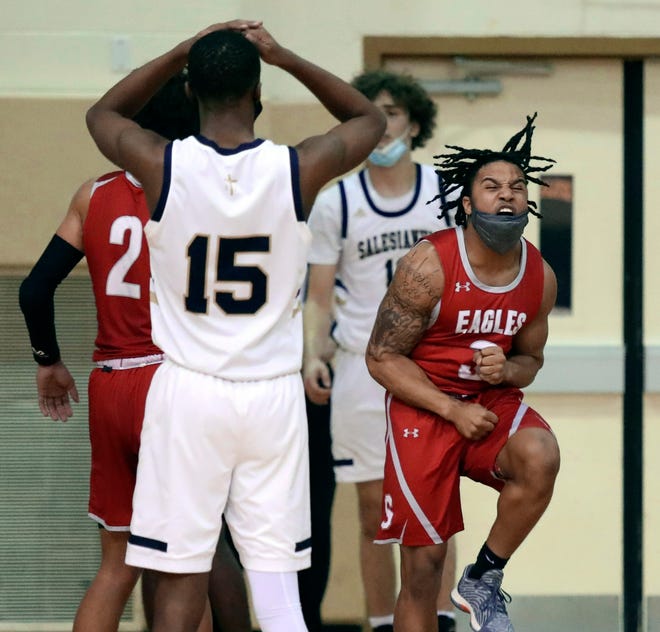 Smyrna's Yamir Knight celebrates a foul call as Salesianum's Rasheen Caulk (15) has an opposite reaction in the Eagles' 43-42 win in a semifinal of the DIAA state tournament at Salesianum Thursday, March 11, 2021.